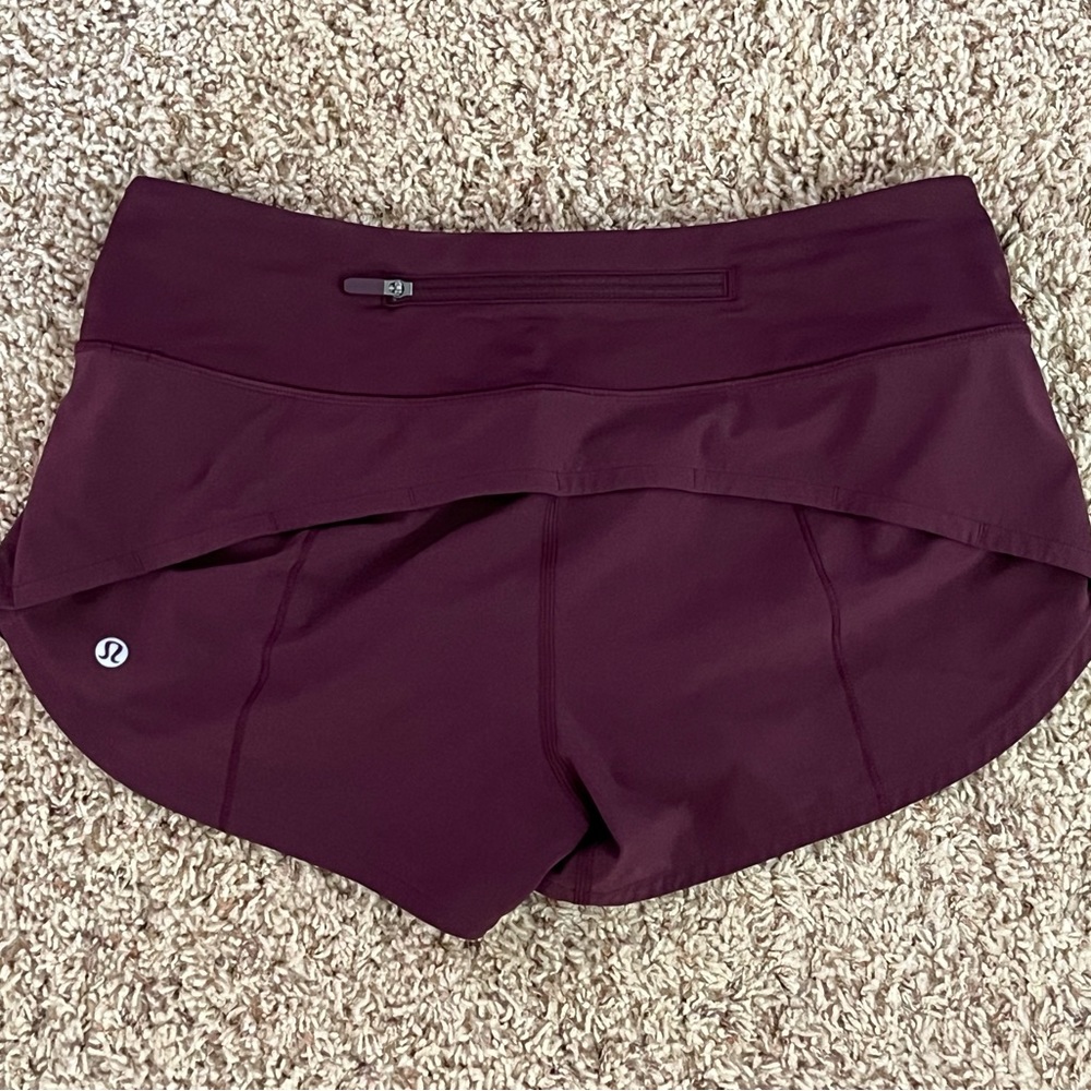 Lululemon Speed Up Shorts wmn’s size 4 burgundy low rise, 2.5 inseam. Never worn